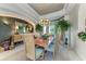 Bright dining room featuring tray ceilings, a stylish chandelier, and large windows at 5224 88Th E St, Bradenton, FL 34211