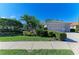 Well-maintained home exterior featuring a three-car garage and meticulously landscaped front yard at 5224 88Th E St, Bradenton, FL 34211