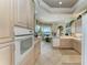 Open kitchen with light-colored cabinetry, tile flooring, and stainless steel appliances at 5224 88Th E St, Bradenton, FL 34211
