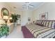 Spacious main bedroom features a ceiling fan, a decorative wall mirror, and an ensuite bathroom at 5224 88Th E St, Bradenton, FL 34211