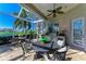 Outdoor kitchen with a stainless steel grill, countertop, and seating area under a screened patio at 5224 88Th E St, Bradenton, FL 34211