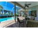 Inviting patio with comfortable seating and views of the pool, spa, and scenic lake beyond at 5224 88Th E St, Bradenton, FL 34211