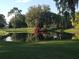 Picturesque water feature with a pond reflecting mature trees, adding to the golf course's tranquil and beautiful landscape at 5224 88Th E St, Bradenton, FL 34211