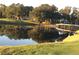 Charming pond featuring a small bridge amidst a lush green golf course, providing a serene and picturesque community space at 5224 88Th E St, Bradenton, FL 34211