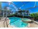 A covered pool and spa overlook a serene lake view on a bright, sunny day at 5224 88Th E St, Bradenton, FL 34211