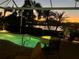 Relaxing evening view of an illuminated pool and spa with a scenic lake backdrop at sunset at 5224 88Th E St, Bradenton, FL 34211