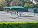Well-maintained tennis court featuring multiple seating areas and sun shelters at 5224 88Th E St, Bradenton, FL 34211