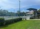 Well-maintained tennis courts with spectator seating and lush landscaping at 5224 88Th E St, Bradenton, FL 34211
