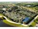 A beautiful aerial view showcasing multiple tennis courts surrounded by lush landscaping and community amenities at 5685 Palmer Cir # 202, Bradenton, FL 34211