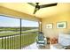 Relaxing balcony with a ceiling fan and picturesque views of the golf course and serene pond at 5685 Palmer Cir # 202, Bradenton, FL 34211