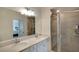 Modern bathroom featuring a double vanity, a glass-enclosed shower, and neutral tile at 5685 Palmer Cir # 202, Bradenton, FL 34211