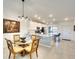 Inviting dining area with a glass-top table, seating for four, and a view of the modern kitchen at 5685 Palmer Cir # 202, Bradenton, FL 34211