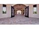 Elegant arched entryway with decorative iron gates, leading to a grand courtyard at 5685 Palmer Cir # 202, Bradenton, FL 34211