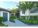 Charming exterior of a condo with lush landscaping, a brick path, and a convenient storage area by the front door at 5685 Palmer Cir # 202, Bradenton, FL 34211