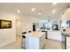 Open-concept kitchen with a central island, stainless steel appliances, and seamless flow to the living area at 5685 Palmer Cir # 202, Bradenton, FL 34211