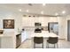 Elegant kitchen featuring white cabinets, modern stainless steel appliances, and an island with barstool seating at 5685 Palmer Cir # 202, Bradenton, FL 34211