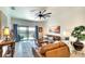 Cozy living room featuring a leather sofa, stylish decor, and sliding glass doors leading to an outdoor area at 5685 Palmer Cir # 202, Bradenton, FL 34211