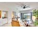 Spacious living room with stylish furnishings, a ceiling fan, and sliding glass doors leading to the outdoors at 5685 Palmer Cir # 202, Bradenton, FL 34211