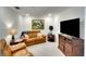 Comfortable living room featuring leather furniture, a large television, and stylish decor at 5685 Palmer Cir # 202, Bradenton, FL 34211