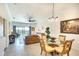 Open-concept living room featuring a comfortable leather sofa, dining area, and sliding glass doors to the outside at 5685 Palmer Cir # 202, Bradenton, FL 34211