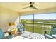 Relaxing screened-in patio featuring comfortable seating and a view of the lush golf course and lake at 5685 Palmer Cir # 202, Bradenton, FL 34211