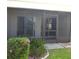 A screened-in back patio area with access from sliding glass doors and green foliage at 5918 7Th W Ave # 5918, Bradenton, FL 34209