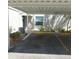 View of the carport with parking spaces under a white corrugated metal roof at 5918 7Th W Ave # 5918, Bradenton, FL 34209