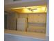 Bright kitchen with white cabinets, tile backsplash, and bar pass through at 5918 7Th W Ave # 5918, Bradenton, FL 34209