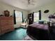Comfortable bedroom featuring a cozy bed, two windows, and ample natural light at 6510 E 26Th Ave, Tampa, FL 33619