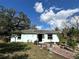 Charming single-story home featuring brick walkway, mature trees, and a well-maintained front yard at 6510 E 26Th Ave, Tampa, FL 33619
