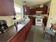 Functional kitchen featuring wood cabinets, stainless steel sink, and a window with natural light at 6510 E 26Th Ave, Tampa, FL 33619