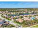 Stunning aerial view of a community featuring beautiful houses along a scenic lake under a clear blue sky at 6600 Horned Owl Pl, Sarasota, FL 34241