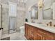 Bathroom featuring tiled walls, double sinks and a standing mirror at 6600 Horned Owl Pl, Sarasota, FL 34241