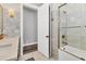 Bathroom featuring tiled walls, a walk-in shower and a separate water closet at 6600 Horned Owl Pl, Sarasota, FL 34241