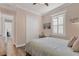 Cozy bedroom with light pink walls, a white closet, and warm lighting at 6600 Horned Owl Pl, Sarasota, FL 34241