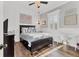Bright bedroom featuring white paneling, dark furniture, and hardwood flooring at 6600 Horned Owl Pl, Sarasota, FL 34241