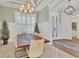 Formal dining room featuring modern light fixture, wainscoting, plantation shutters and large table seating six at 6600 Horned Owl Pl, Sarasota, FL 34241