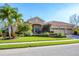 Attractive single-story home featuring a well-manicured lawn, professional landscaping and a three car garage at 6600 Horned Owl Pl, Sarasota, FL 34241