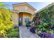 Inviting entrance with brick walkway, covered archway, and tropical plants at 6600 Horned Owl Pl, Sarasota, FL 34241