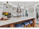 Kitchen with stainless steel appliances, a center island with seating, and modern pendant lights at 6600 Horned Owl Pl, Sarasota, FL 34241