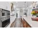 Modern kitchen with stainless steel appliances, white cabinetry, and a large center island at 6600 Horned Owl Pl, Sarasota, FL 34241