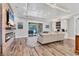 Inviting living room with fireplace, wood floors, and access to outdoor patio at 6600 Horned Owl Pl, Sarasota, FL 34241