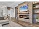 Comfortable living room features a modern fireplace with stone surround and wood floors at 6600 Horned Owl Pl, Sarasota, FL 34241