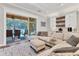 Living room with comfortable seating and a view of the outdoor pool and patio at 6600 Horned Owl Pl, Sarasota, FL 34241