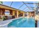 Luxurious outdoor area featuring a stunning pool and a full outdoor kitchen setup at 6600 Horned Owl Pl, Sarasota, FL 34241