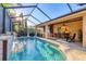Beautiful screened-in pool area with an outdoor kitchen and bar, perfect for entertaining guests at 6600 Horned Owl Pl, Sarasota, FL 34241