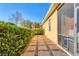 A well-maintained side yard with lush landscaping, paving stones, and a privacy screen at 6600 Horned Owl Pl, Sarasota, FL 34241