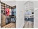 Large walk-in closet with built-in shelving and hanging racks, connected to a bedroom with elegant design at 6600 Horned Owl Pl, Sarasota, FL 34241