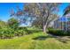Green backyard lawn featuring an enclosing screened-in patio providing a relaxing view of a golf course at 7718 Heathfield Ct, University Park, FL 34201