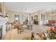 Open living room with tile floors, fireplace, comfortable seating, and seamless transition to the dining area at 7718 Heathfield Ct, University Park, FL 34201